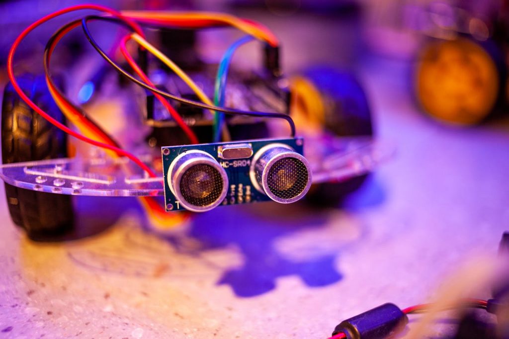 Detailed view of a robotic vehicle component showcasing wires and sensors.